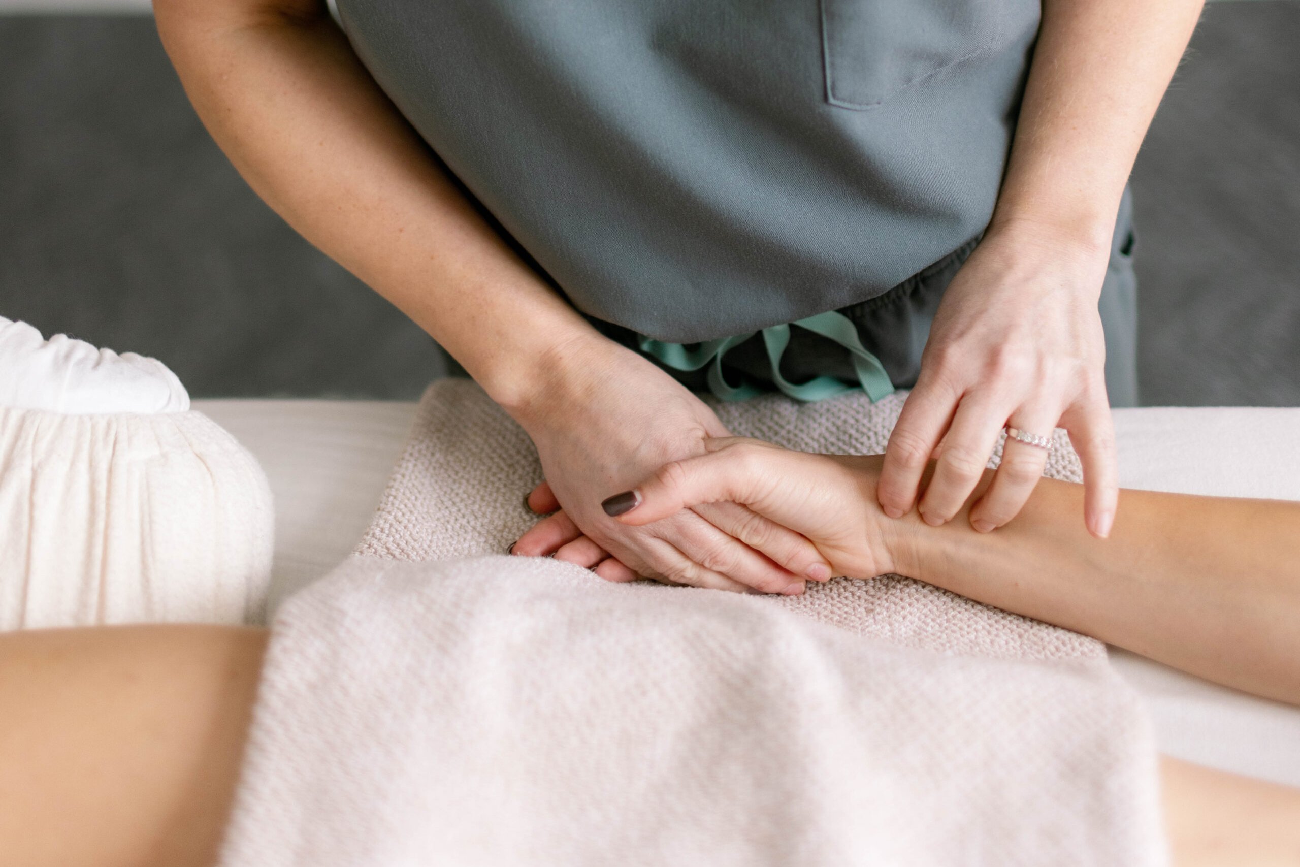 Acupuncturist gently treating a patient during IVF support at Shen Medicine in Nashville