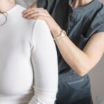 Shen Medicine practitioner easing neck and shoulder tension for a mom dealing with stress and burnout in Nashville