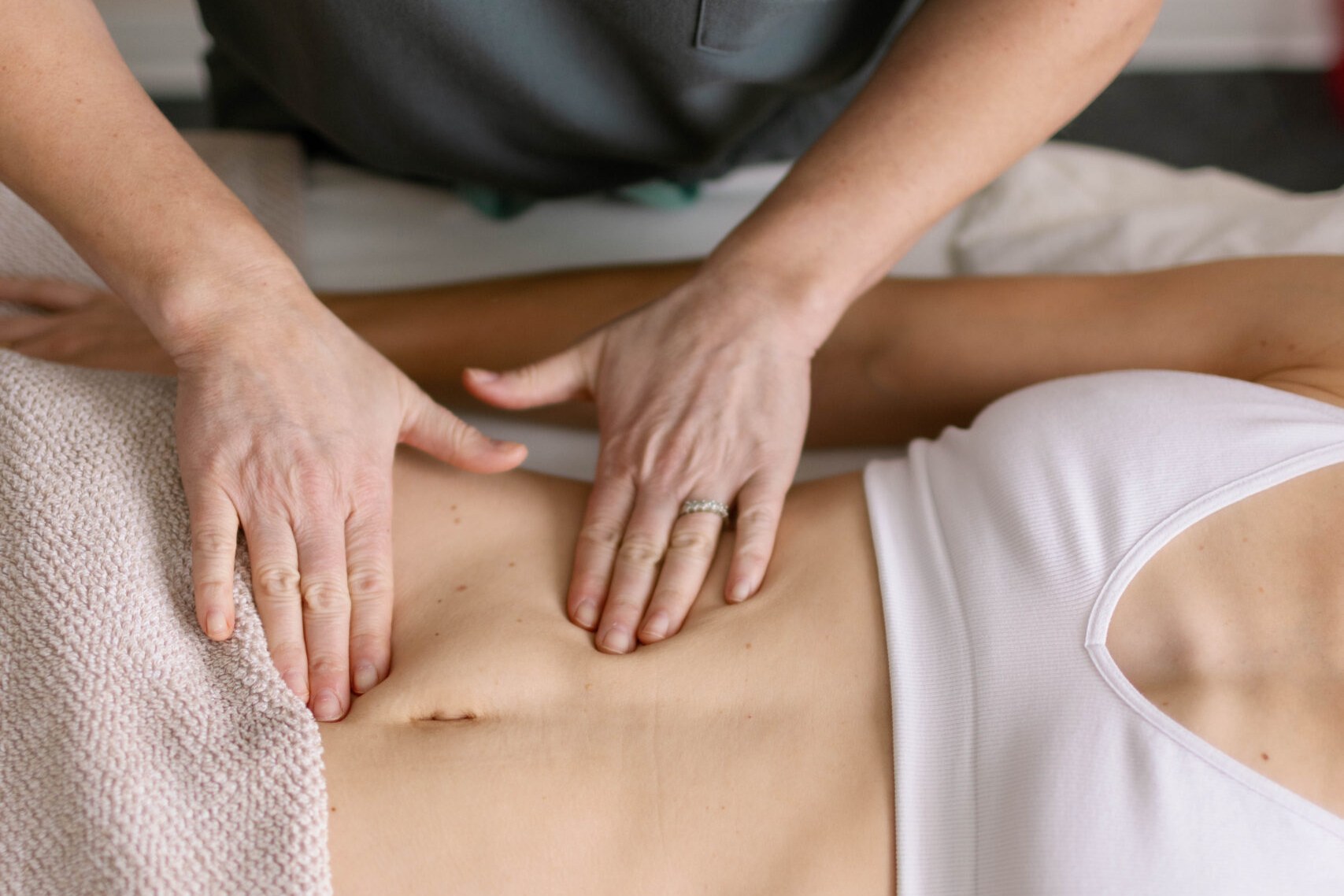 Acupuncturist performing gentle abdominal work for PCOS and PMOS support at Shen Medicine in Nashville